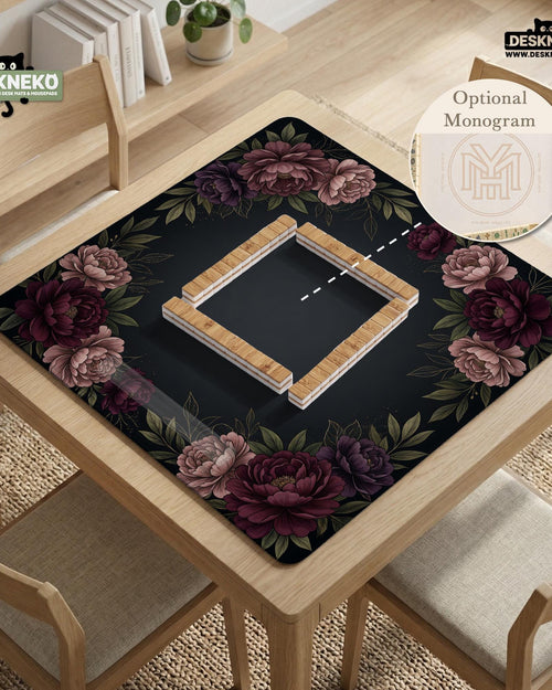 A square mahjong mat with a black background, burgundy peony flowers, and a botanical border around the edges.