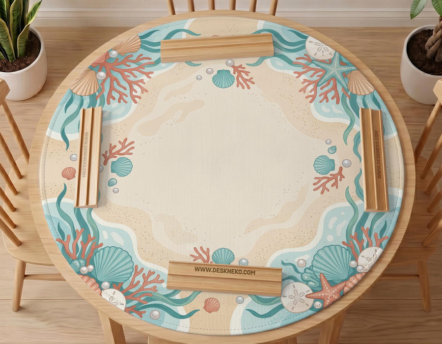 Aqua mahjong mat with seashell and coral artwork, pearl details, and a soft beach color palette in turquoise, cream, and sandy tones.