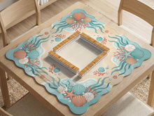 Pastel mahjong mat with a scalloped edge design featuring coral pink shells, aqua starfish, pearls, sand dollars, and a soft sea-inspired pattern.