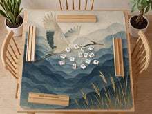 Square mahjong mat with an indigo and blue mountain landscape, two cranes, and cream-toned water or mist details.