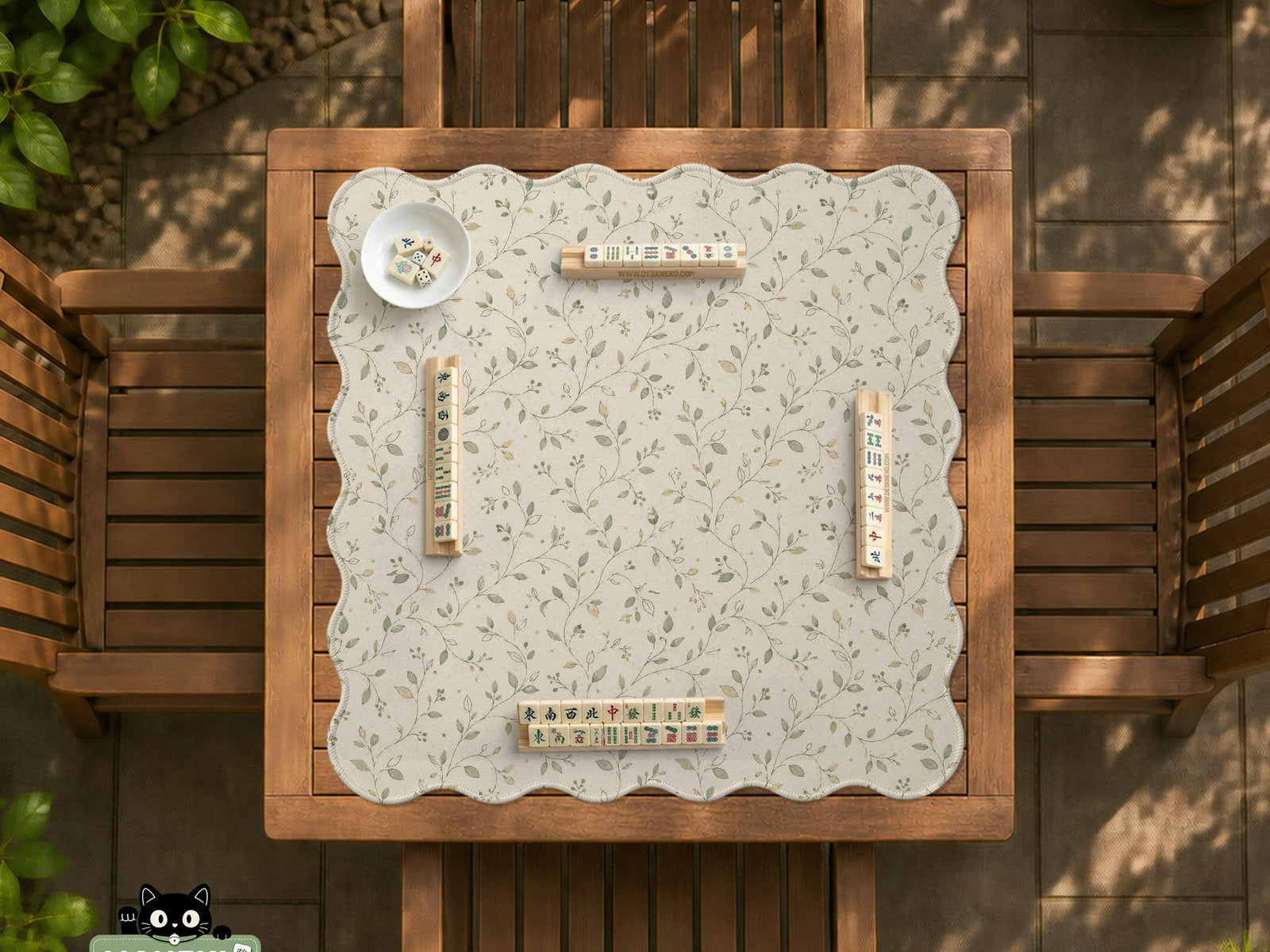 Cream square mahjong mat with a sage vine and leaf botanical pattern and scalloped edges.