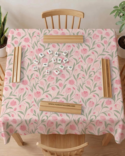 Pink mahjong mat with a botanical tulip floral pattern in blush tones, shown in a tablecloth-style square layout.