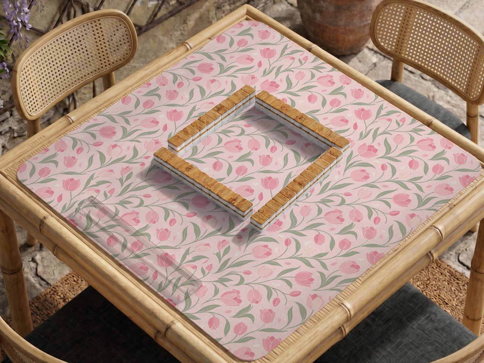 A pink mahjong mat with tulip flowers, sage leaves, and a light pastel background.