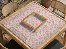 A pink mahjong mat with tulip flowers, sage leaves, and a light pastel background.