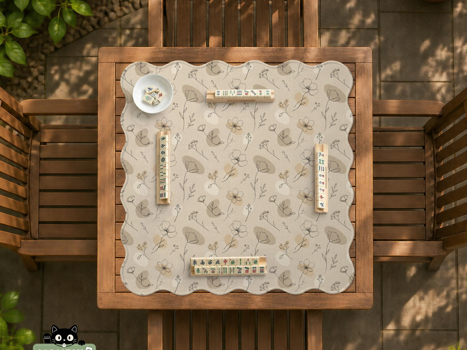 Neutral floral mahjong mat with delicate botanical line art and a scalloped edge on a cream background.