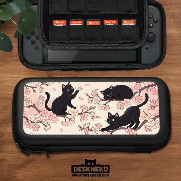 Switch case with black cats and cherry blossoms on a light pastel background.