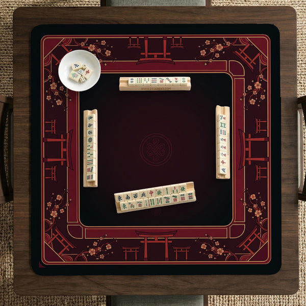 Square burgundy mahjong mat with a cherry blossom floral border and a dark open center.