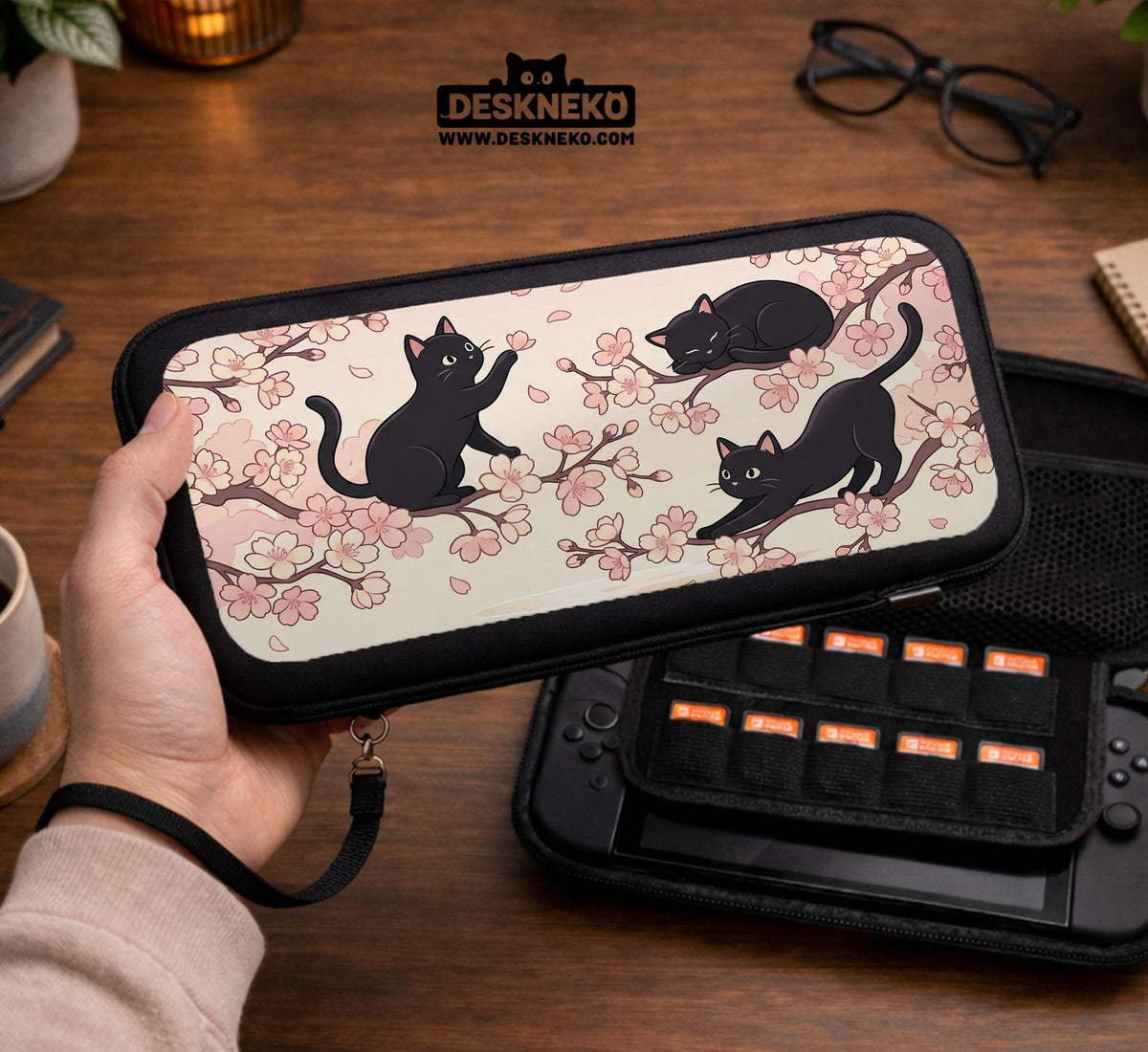 Switch case with black cats and cherry blossoms on a light pastel background.