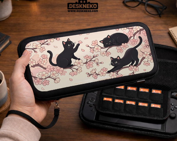 Switch case with black cats and cherry blossoms on a light pastel background.