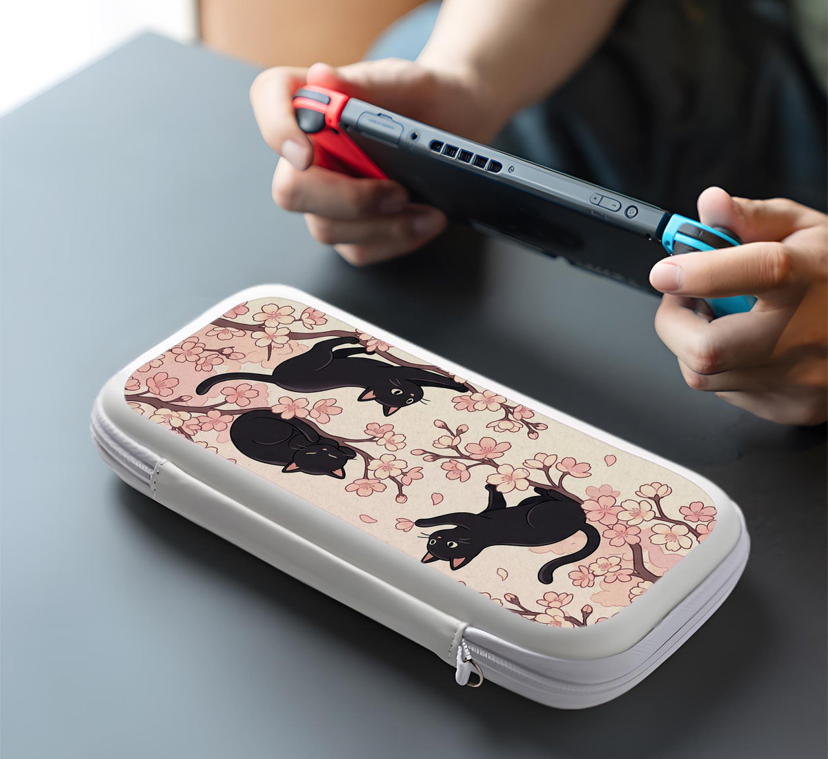 Switch case with black cats and cherry blossoms on a light pastel background.