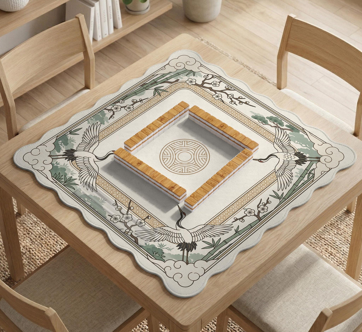 Square mahjong table mat with a cream center and a border design of cranes, bamboo, plum blossoms, and a geometric frame in sage green and warm gold.