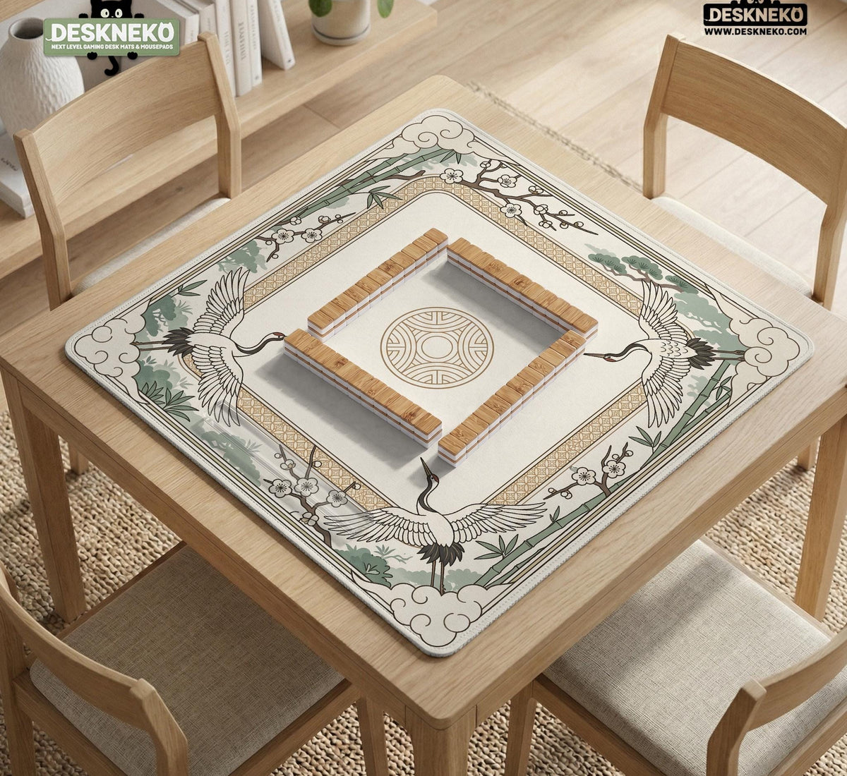 Square mahjong table mat with a cream center and a border design of cranes, bamboo, plum blossoms, and a geometric frame in sage green and warm gold.