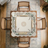 Square mahjong table mat with a cream center and a border design of cranes, bamboo, plum blossoms, and a geometric frame in sage green and warm gold.