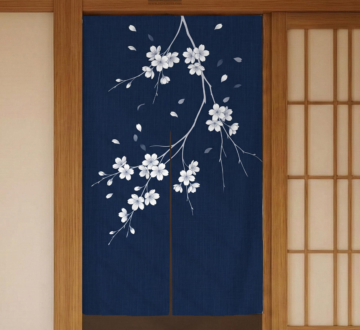 Navy door curtain with pink cherry blossom branches and a light floral layout on a dark background.