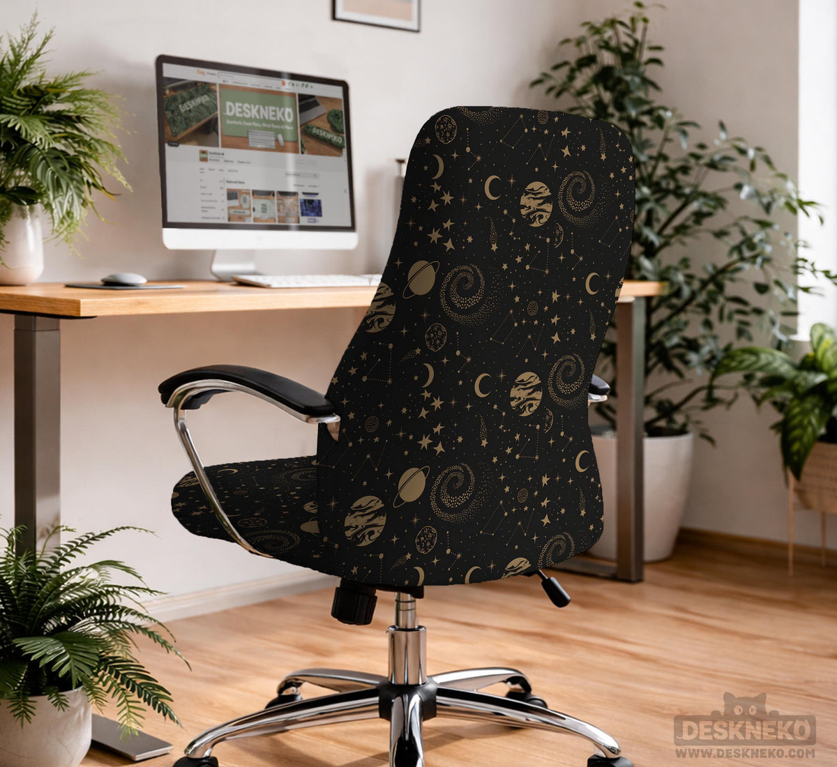 Black chair cover with a dark galaxy pattern, muted gold stars and celestial artwork on a chair.