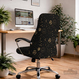 Black chair cover with a dark galaxy pattern, muted gold stars and celestial artwork on a chair.