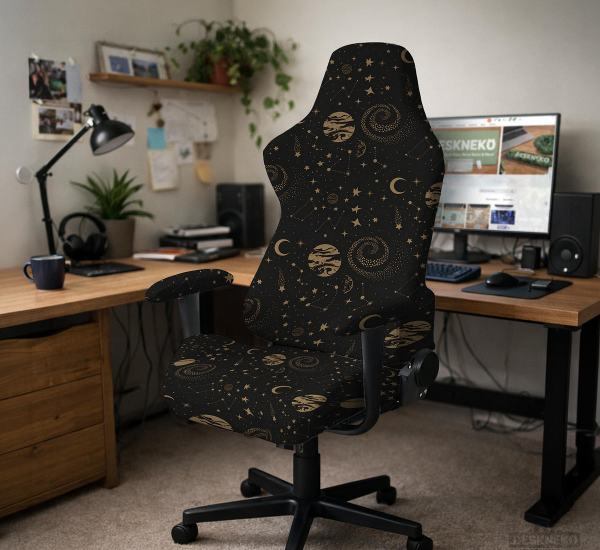 Black chair cover with a dark galaxy pattern, muted gold stars and celestial artwork on a chair.