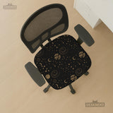 Black chair cover with a dark galaxy pattern, muted gold stars and celestial artwork on a chair.
