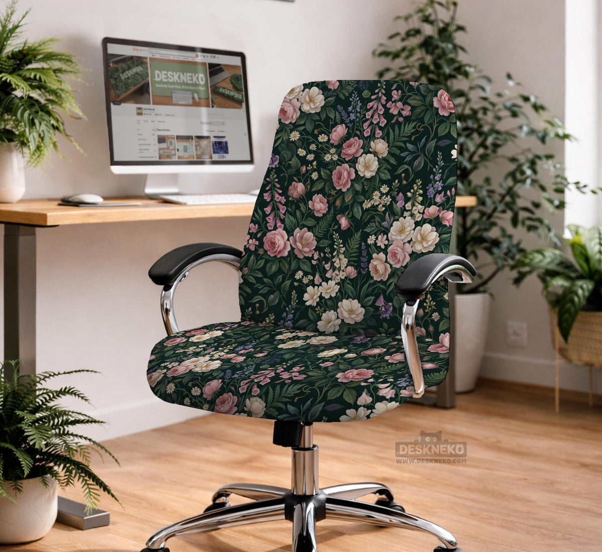 Green chair cover with a dark floral pattern, pink roses, cream flowers, and leafy botanical details on an office chair.