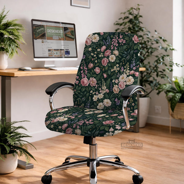 Green chair cover with a dark floral pattern, pink roses, cream flowers, and leafy botanical details on an office chair.