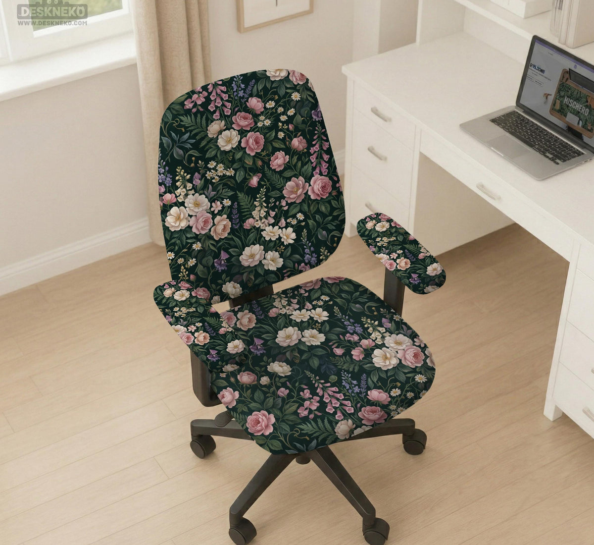 Green chair cover with a dark floral pattern, pink roses, cream flowers, and leafy botanical details on an office chair.