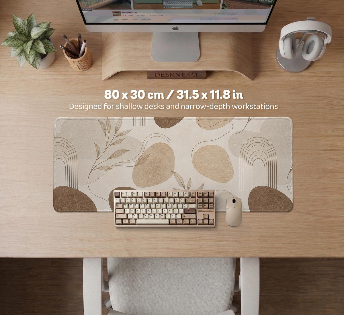 Beige desk mat with fine botanical line drawings and soft abstract shapes on a light neutral background.