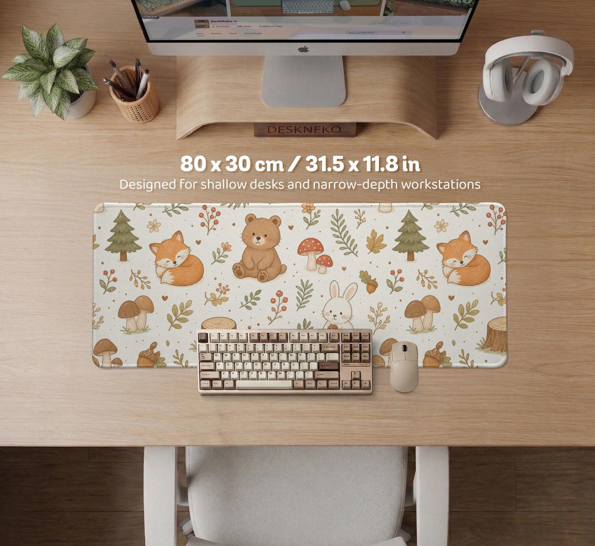 Cream desk mat with a woodland animal pattern featuring foxes, bunnies, mushrooms, berries, acorns, and sage leaves in soft green tones.