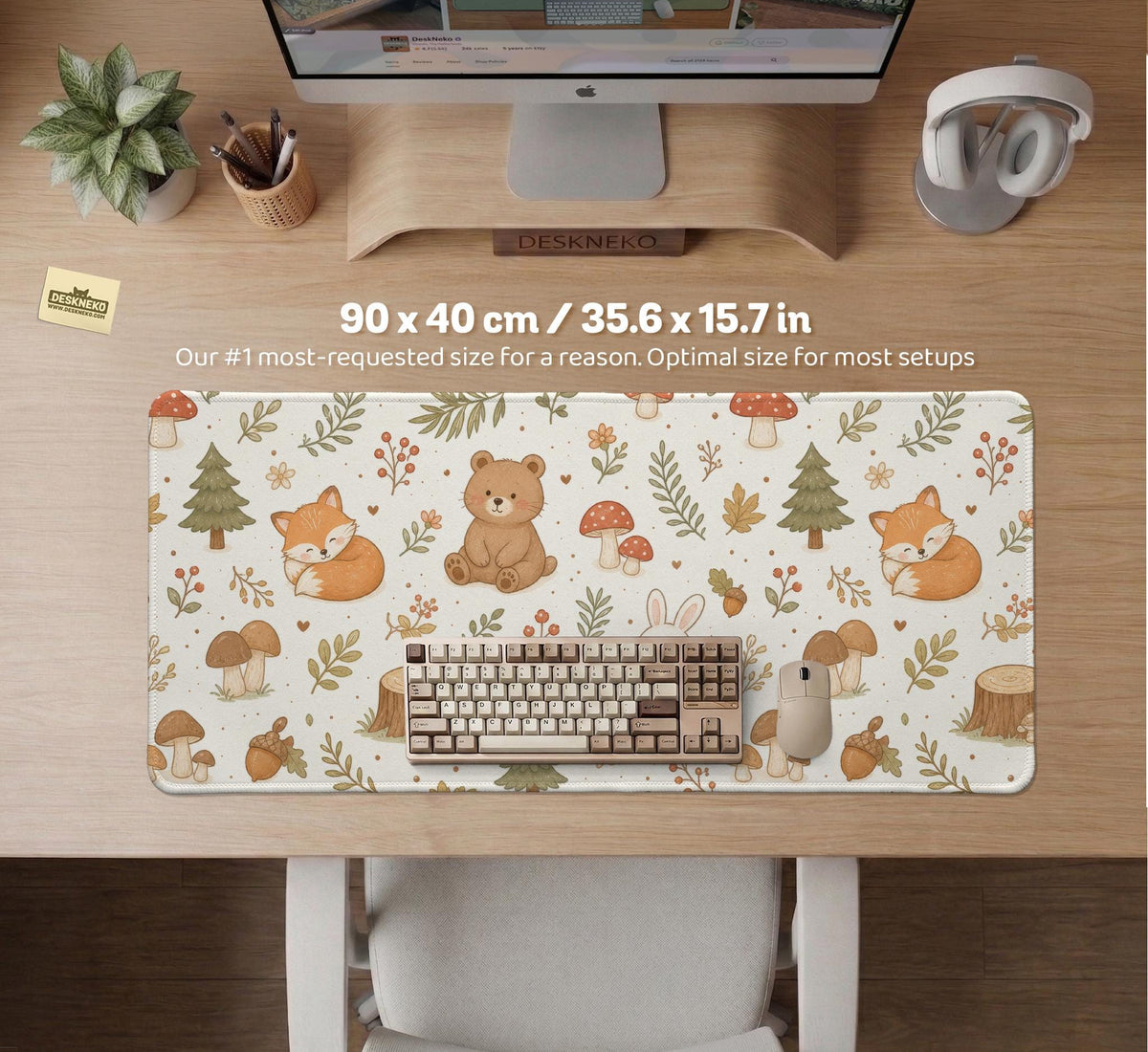 Cream desk mat with a woodland animal pattern featuring foxes, bunnies, mushrooms, berries, acorns, and sage leaves in soft green tones.