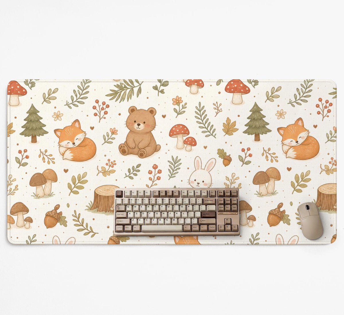 Cream desk mat with a woodland animal pattern featuring foxes, bunnies, mushrooms, berries, acorns, and sage leaves in soft green tones.