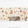 Cream desk mat with a woodland animal pattern featuring foxes, bunnies, mushrooms, berries, acorns, and sage leaves in soft green tones.