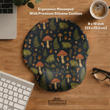 Dark botanical desk mat options with frogs, mushrooms, ferns, and acorns in brown and green tones, plus a matching keyboard wrist rest.