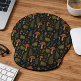 Dark botanical desk mat options with frogs, mushrooms, ferns, and acorns in brown and green tones, plus a matching keyboard wrist rest.
