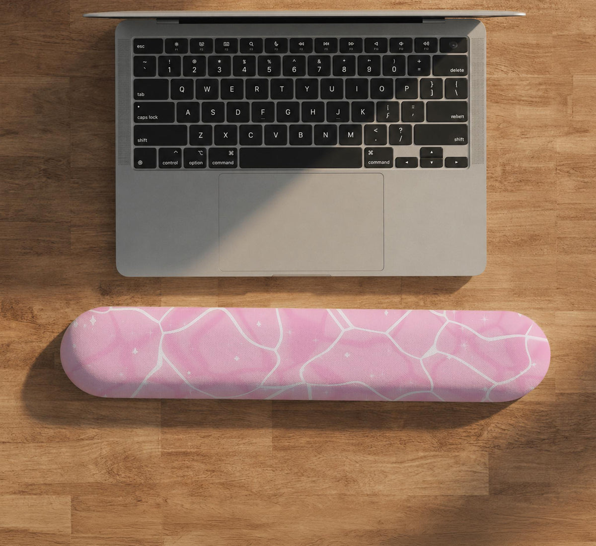 Soft pink mouse pad and wrist rest with a cloud-marble pattern, pale linework, and small star details.