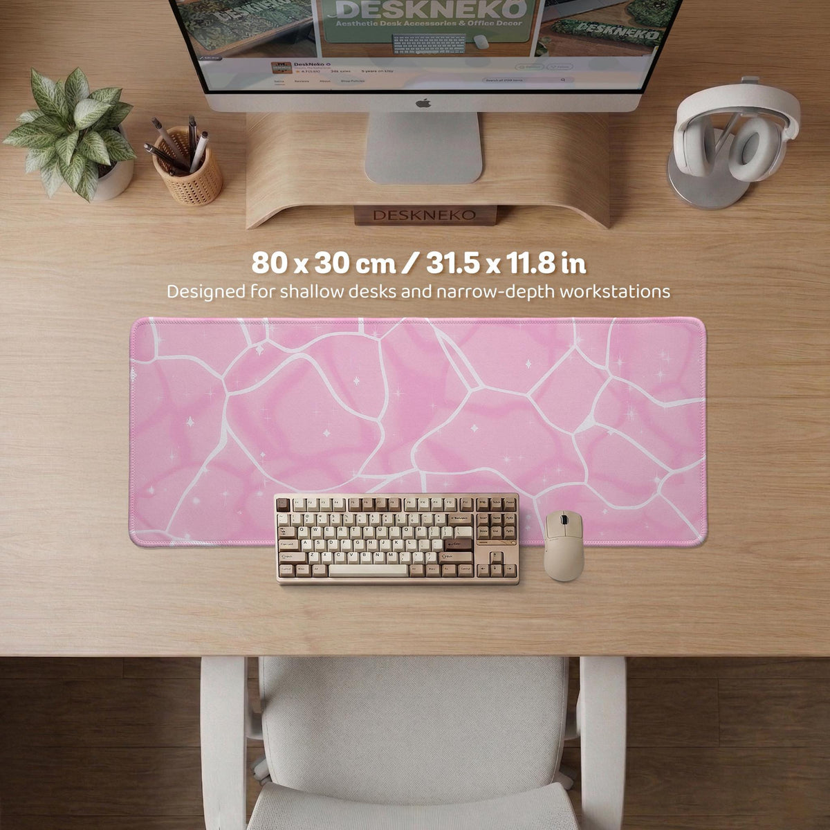 Pastel pink desk mat with a marble-style design, white flowing lines, and small sparkle accents.