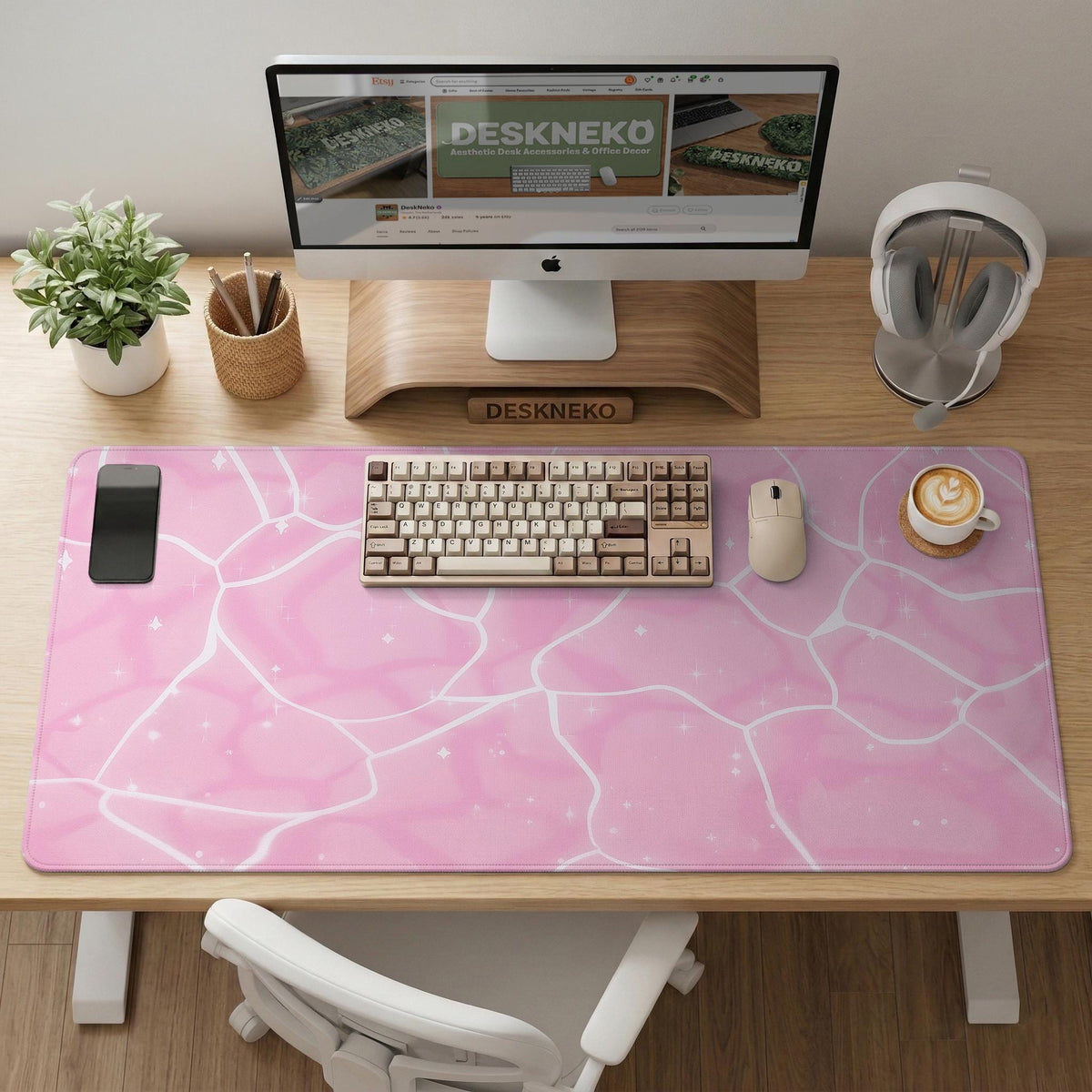 Pastel pink desk mat with a marble-style design, white flowing lines, and small sparkle accents.