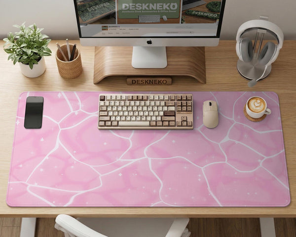 Pastel pink desk mat with a marble-style design, white flowing lines, and small sparkle accents.