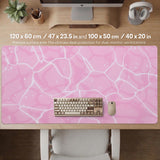 Pastel pink desk mat with a marble-style design, white flowing lines, and small sparkle accents.