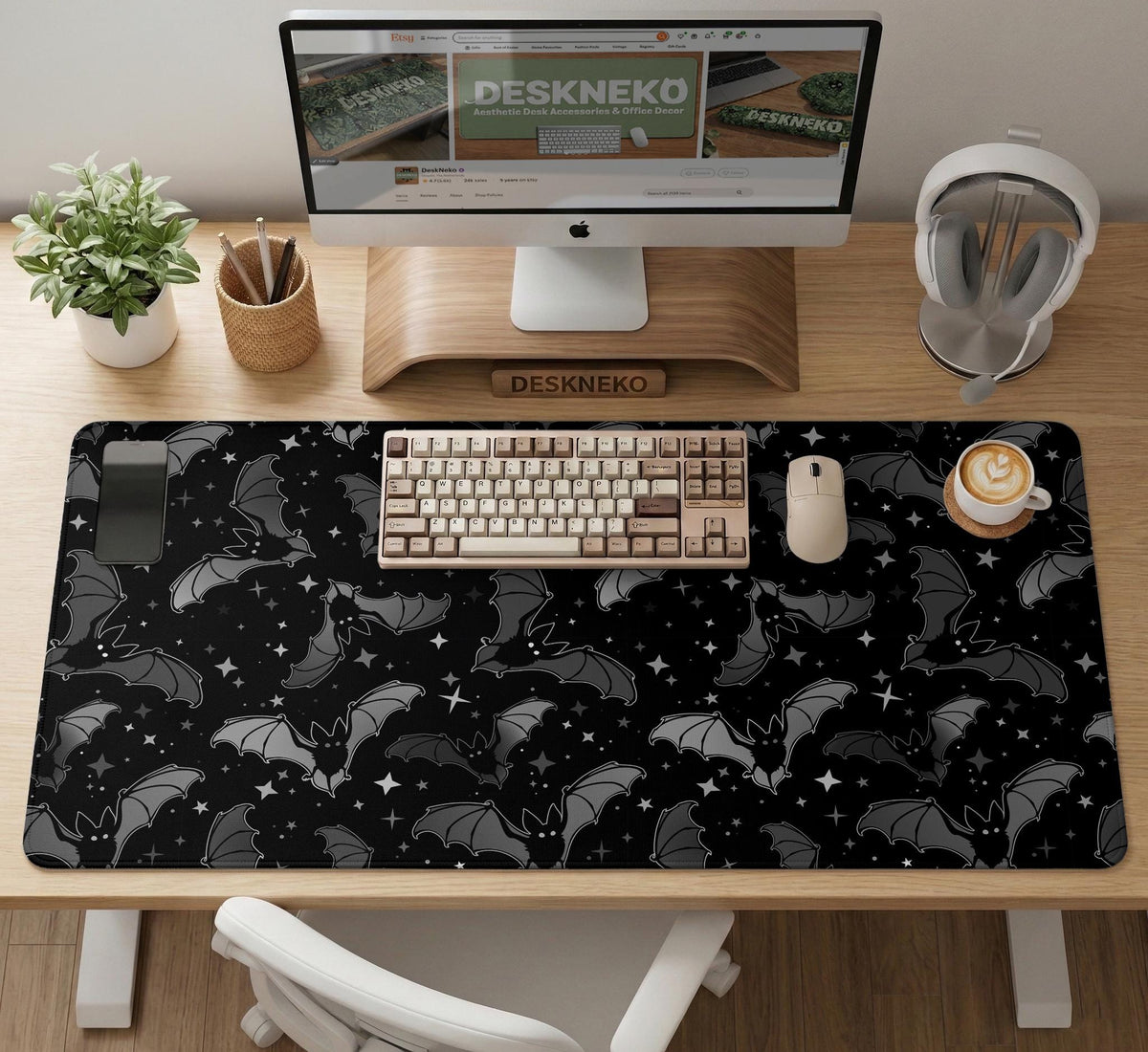 Black desk mat with a dark bat pattern and scattered stars on a charcoal background.