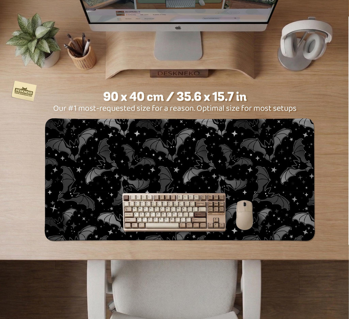 Black desk mat with a dark bat pattern and scattered stars on a charcoal background.