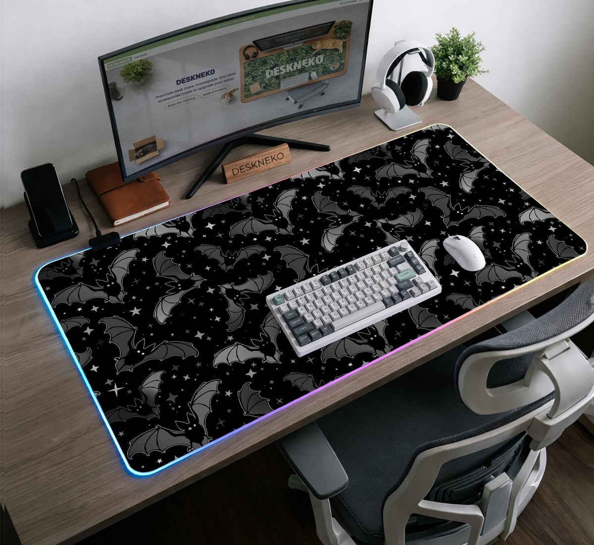 Black desk mat with a dark bat pattern and scattered stars on a charcoal background.