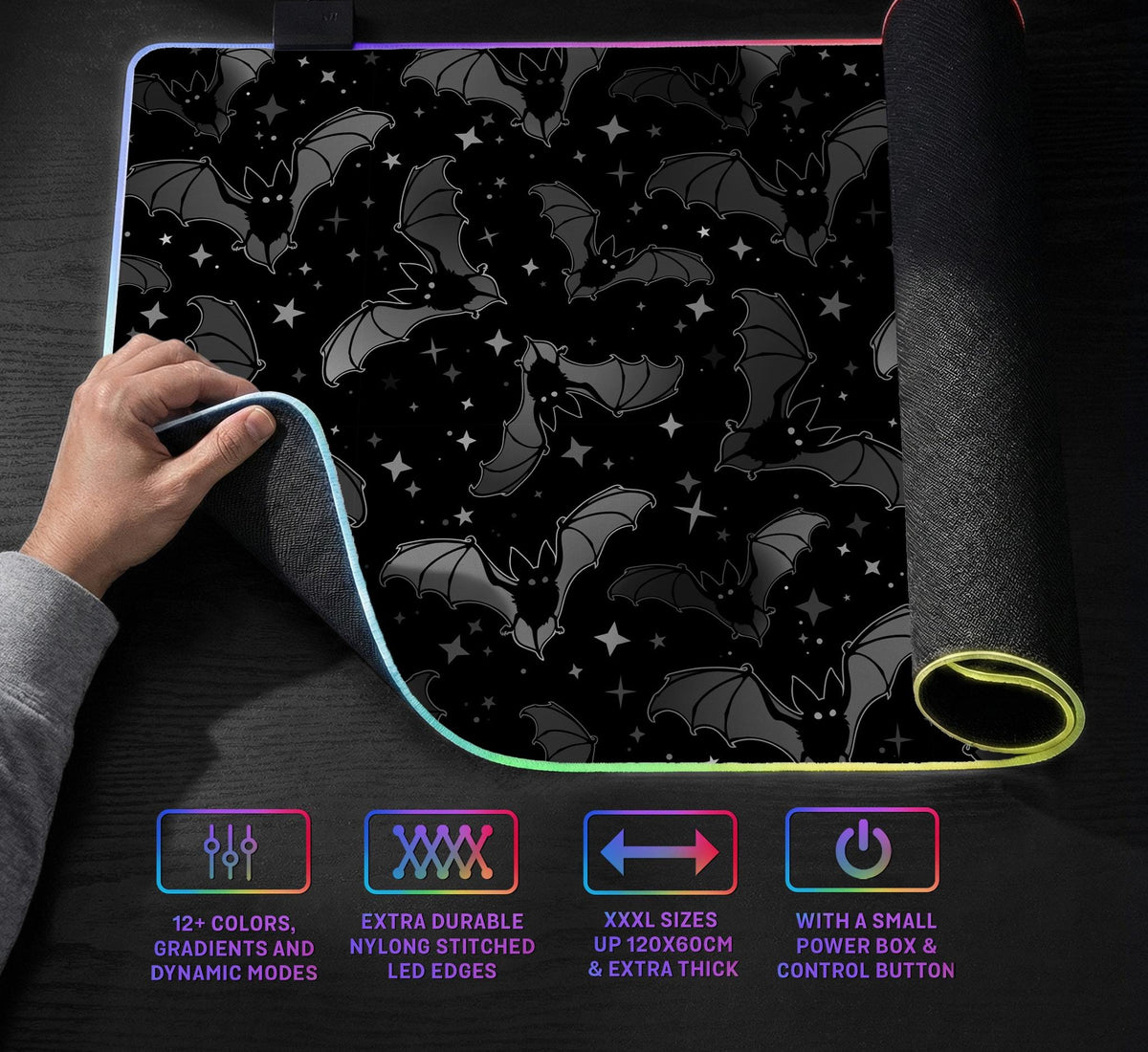 Black desk mat with a dark bat pattern and scattered stars on a charcoal background.