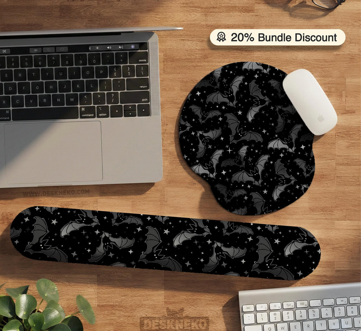 Black desk mat with a dark bat pattern and scattered stars on a charcoal background.