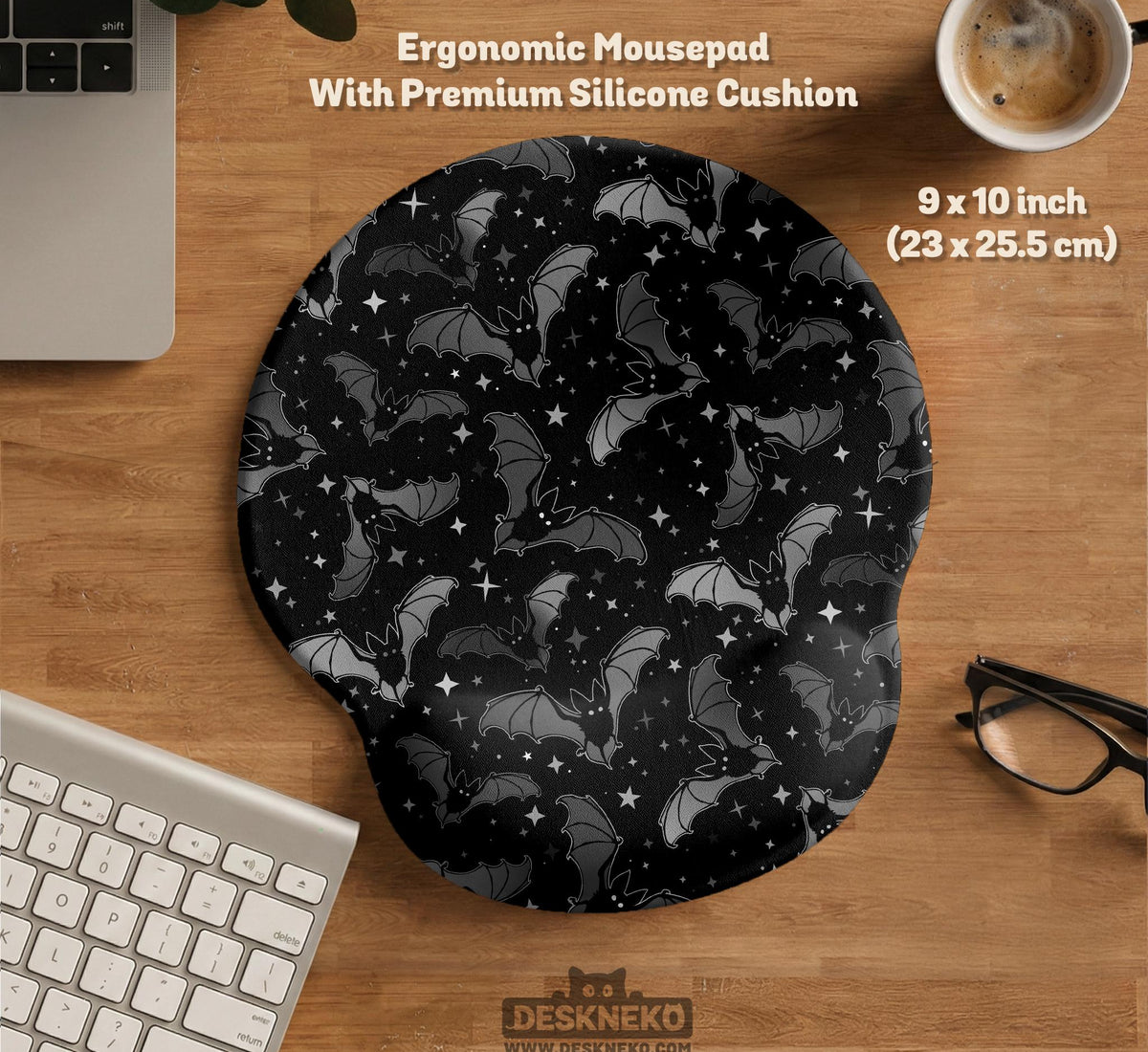Black desk mat with a dark bat pattern and scattered stars on a charcoal background.