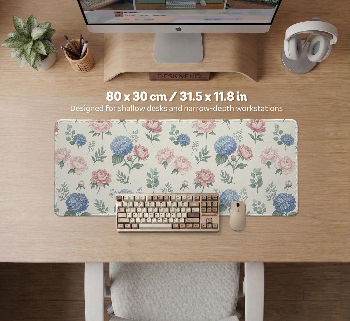 Floral desk mat with sage greenery, pink peonies, blue flowers, and a warm cream background.
