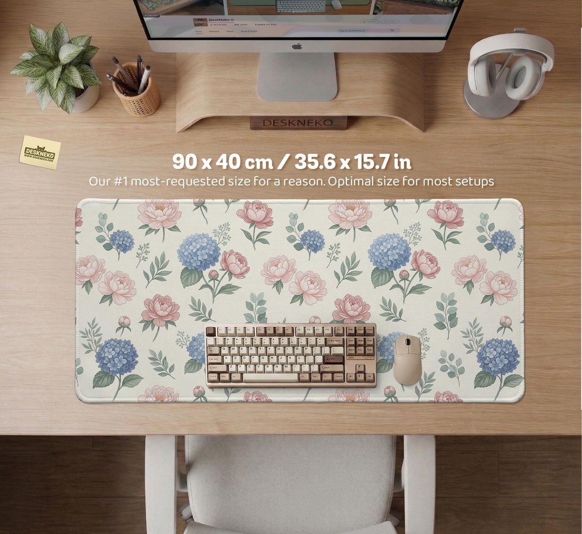 Floral desk mat with sage greenery, pink peonies, blue flowers, and a warm cream background.