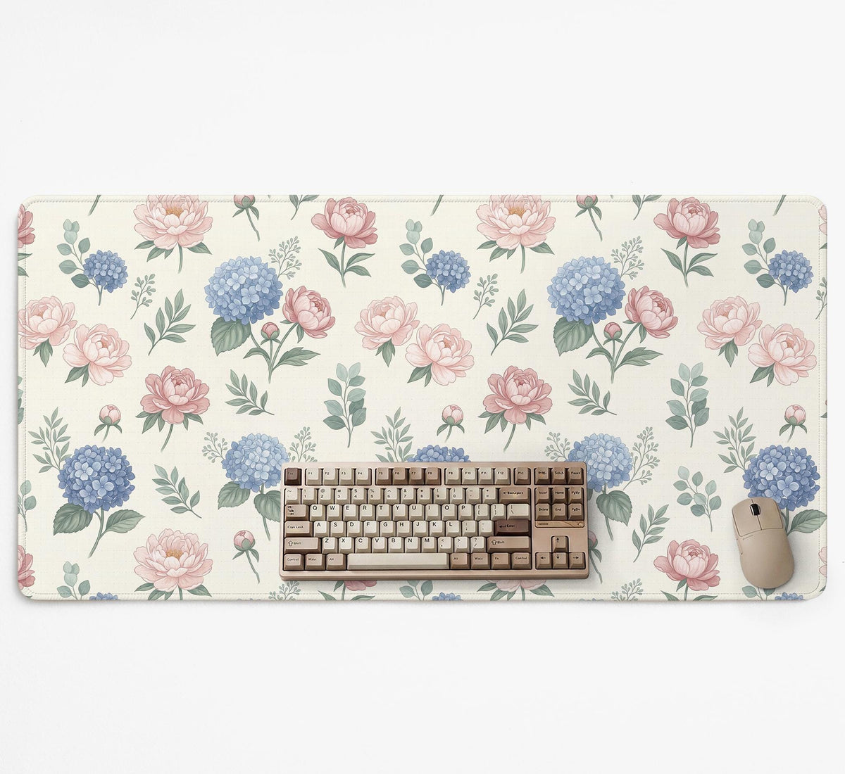 Floral desk mat with sage greenery, pink peonies, blue flowers, and a warm cream background.