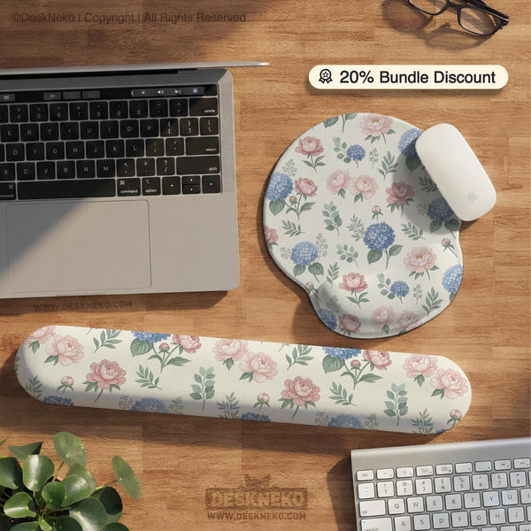 Floral desk mat with sage greenery, pink peonies, blue flowers, and a warm cream background.