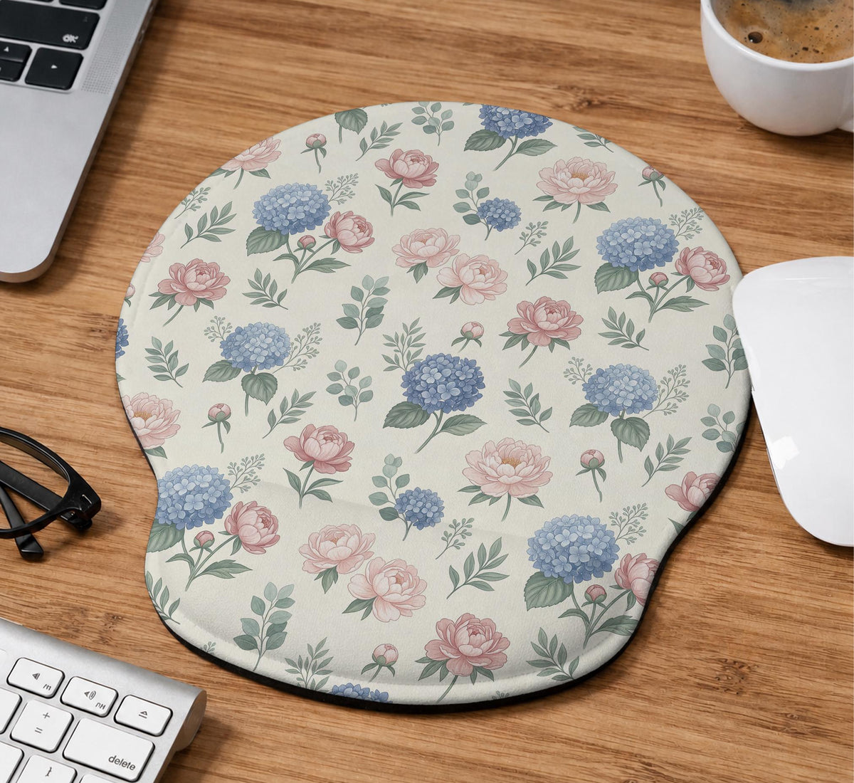 Mousepad and keyboard wrist rest with a floral print of blue hydrangeas, pink peonies, sage leaves, and a cream background.