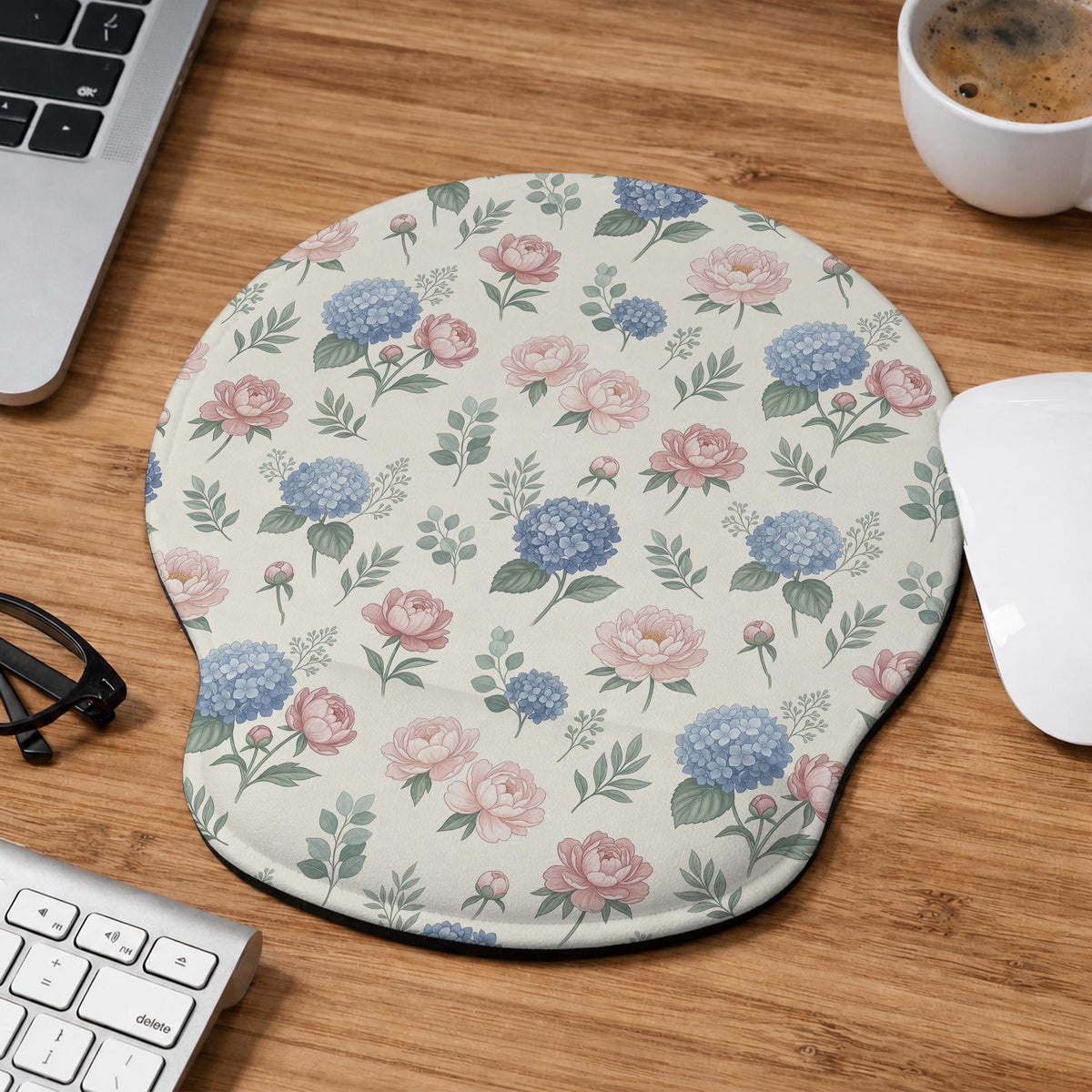 Mousepad and keyboard wrist rest with a floral print of blue hydrangeas, pink peonies, sage leaves, and a cream background.