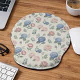 Mousepad and keyboard wrist rest with a floral print of blue hydrangeas, pink peonies, sage leaves, and a cream background.